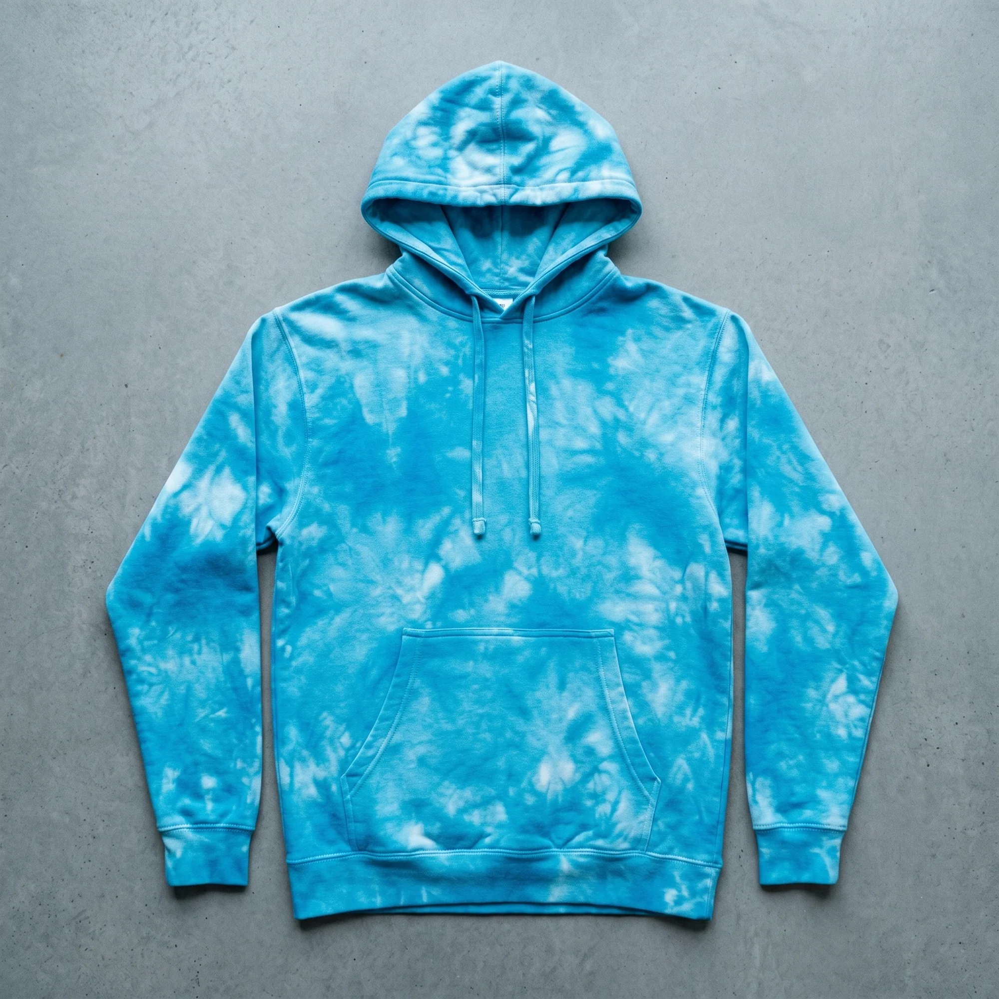 Aqua tie-dye hoodie laid flat, showing the front, hood, and kangaroo pocket