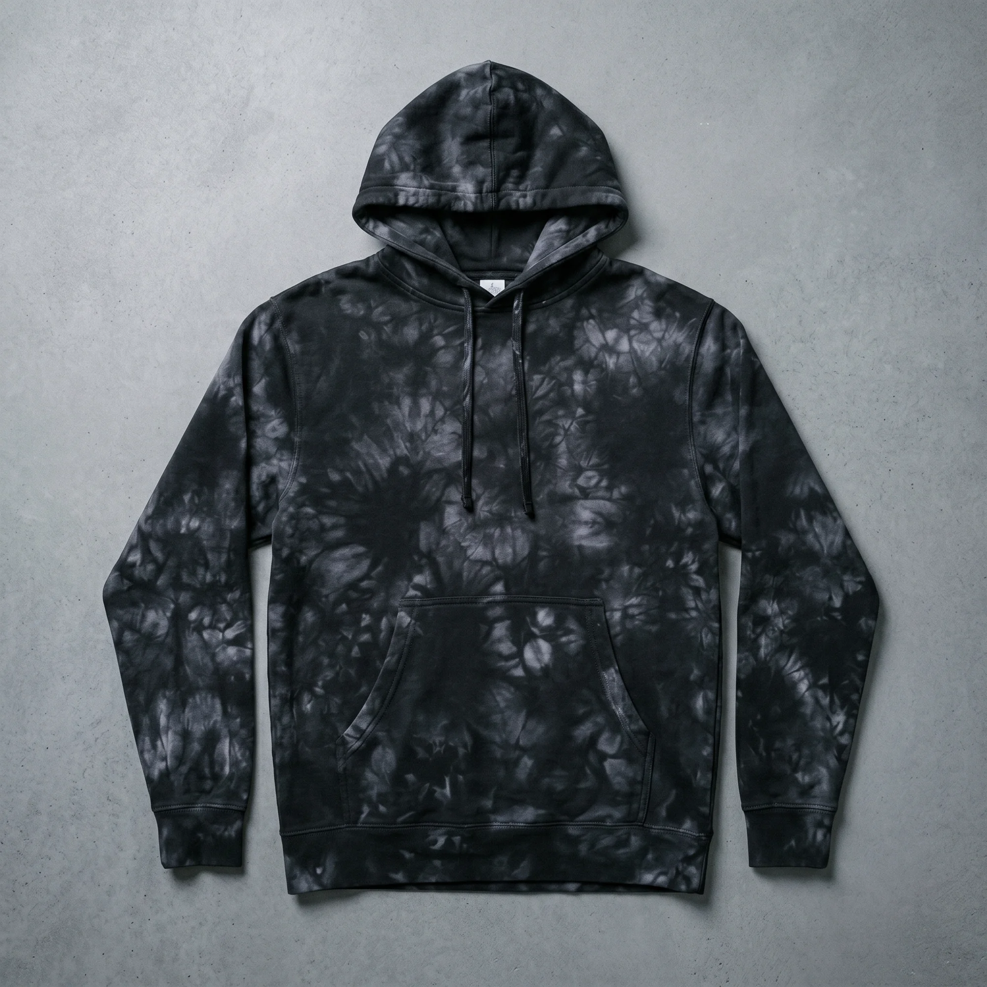 Black tie-dye hoodie laid flat, showing the front, hood, and kangaroo pocket