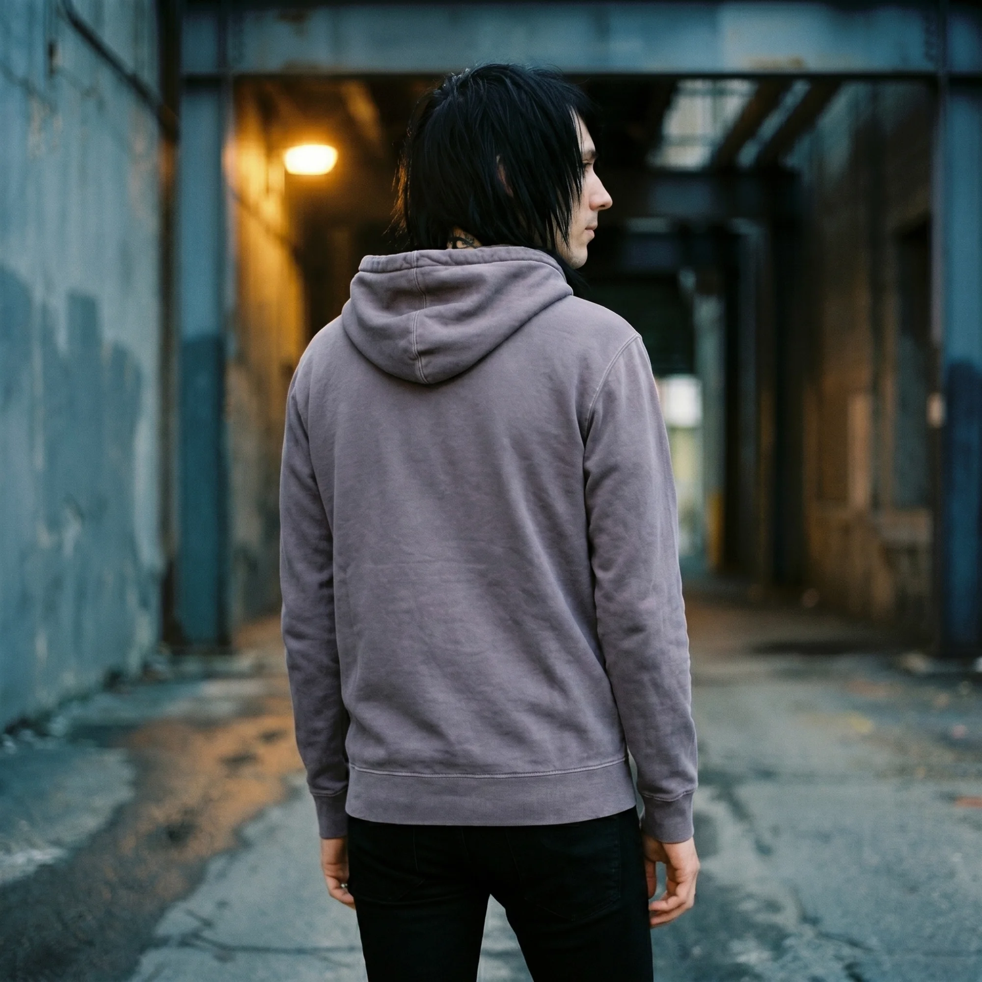 Back view of a man wearing a plum pigment dye hoodie, showing the fit and hood