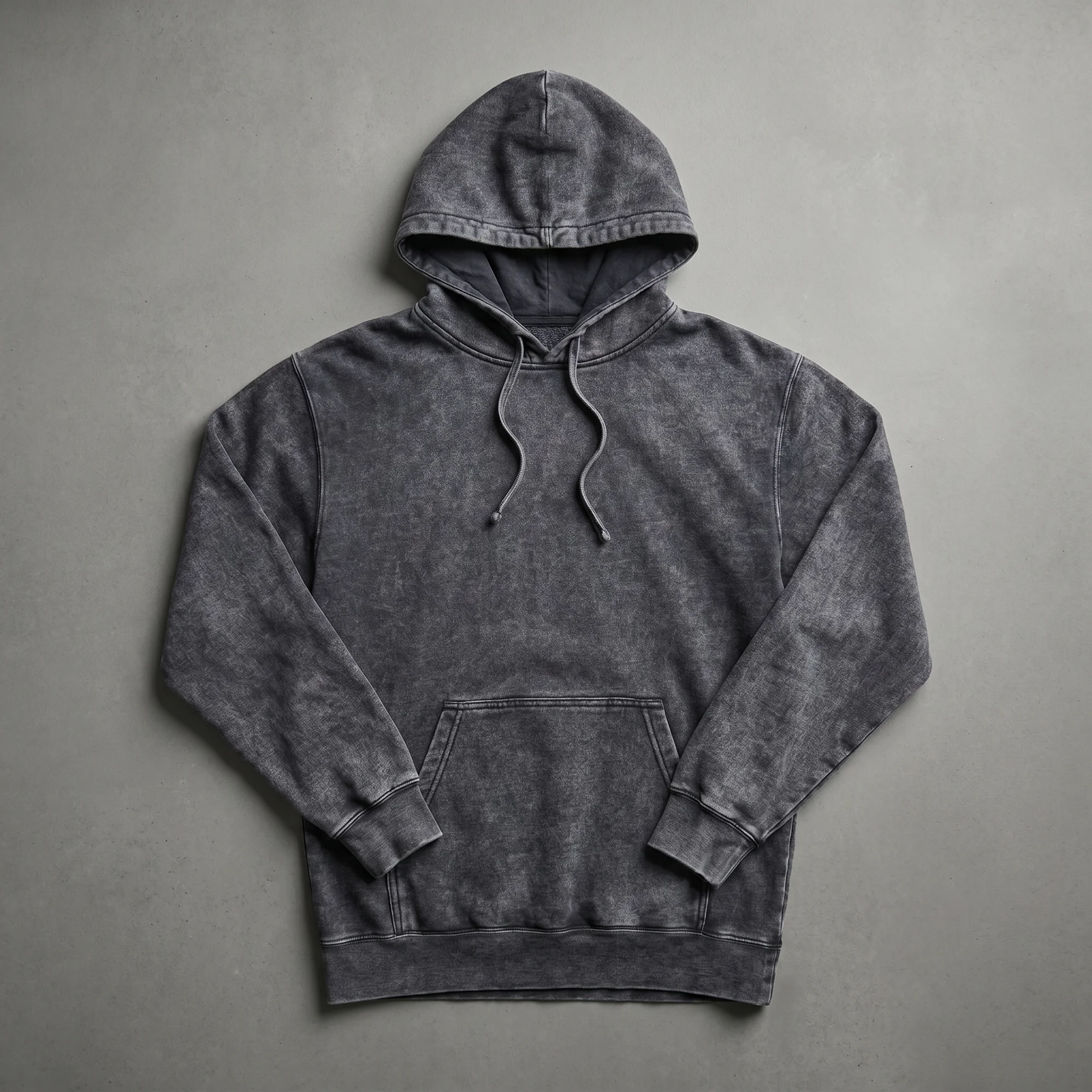 Black mineral wash hoodie laid flat, showing the front, hood, drawstrings, and kangaroo pocket