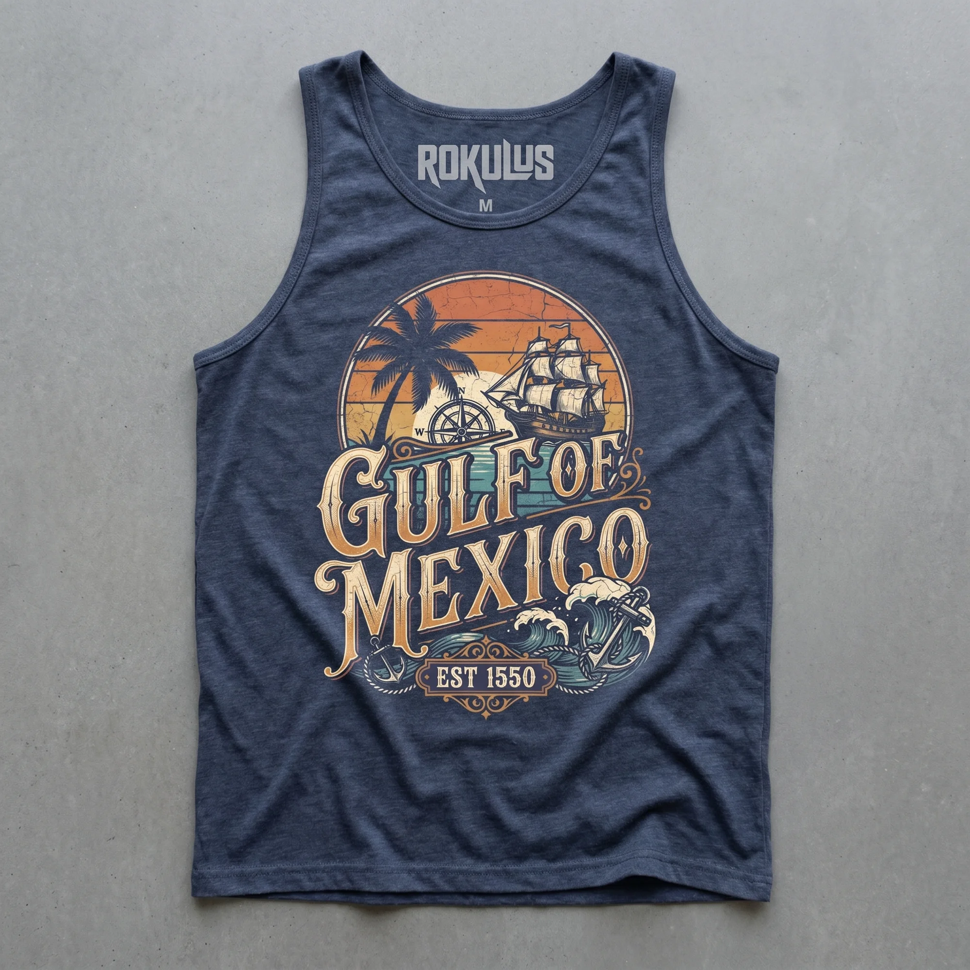 Heather navy tank top laid flat on concrete, showing the Gulf of Mexico graphic with a tall ship, palm tree, compass rose, and "Est 1550" banner