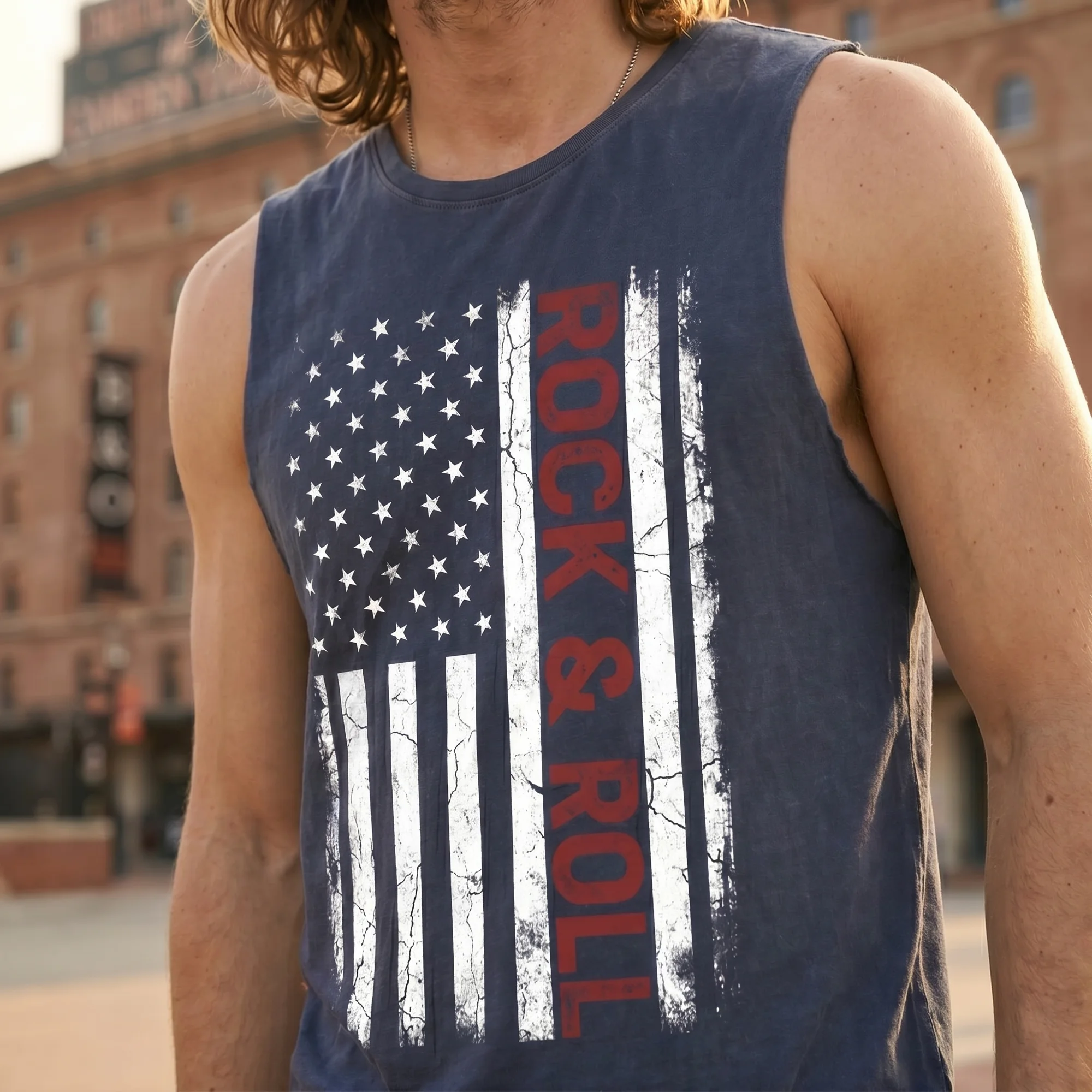 Close-up front view of a man wearing a blue stone wash tank top with the weathered American flag and vertical "Rock & Roll" graphic