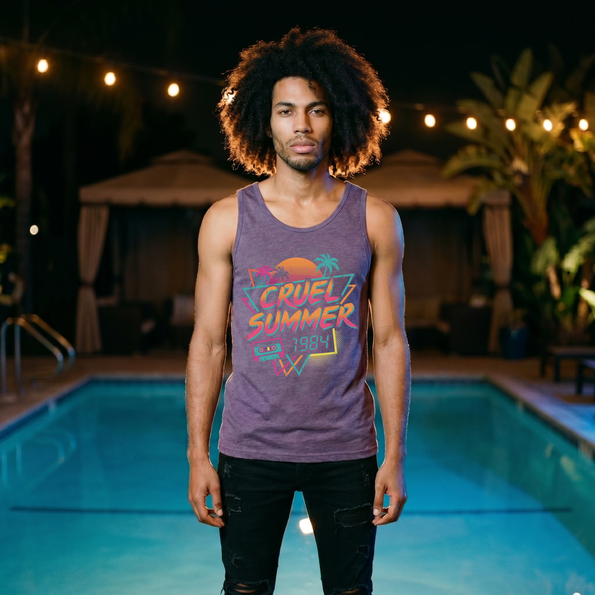Man with an afro wearing a heather purple Cruel Summer 1984 tank top, front view, standing by a lit pool at night