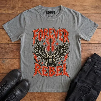 Washed grey Rokulus Forever Rebel vintage graphic tee laid flat on wood with black boots and jeans, front print showing a winged electric guitar in flames with lightning bolts and stars under jagged “Forever Rebel” metal lettering
