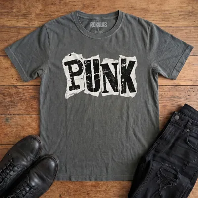 Washed charcoal Rokulus Punk vintage graphic tee laid flat on wood with black boots and jeans, front print showing the word “Punk” in bold cut-and-paste ransom-note letters on torn distressed paper