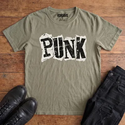 Washed olive Rokulus Punk vintage graphic tee laid flat on wood with black boots and jeans, front print showing the word “Punk” in bold cut-and-paste ransom-note letters on torn distressed paper