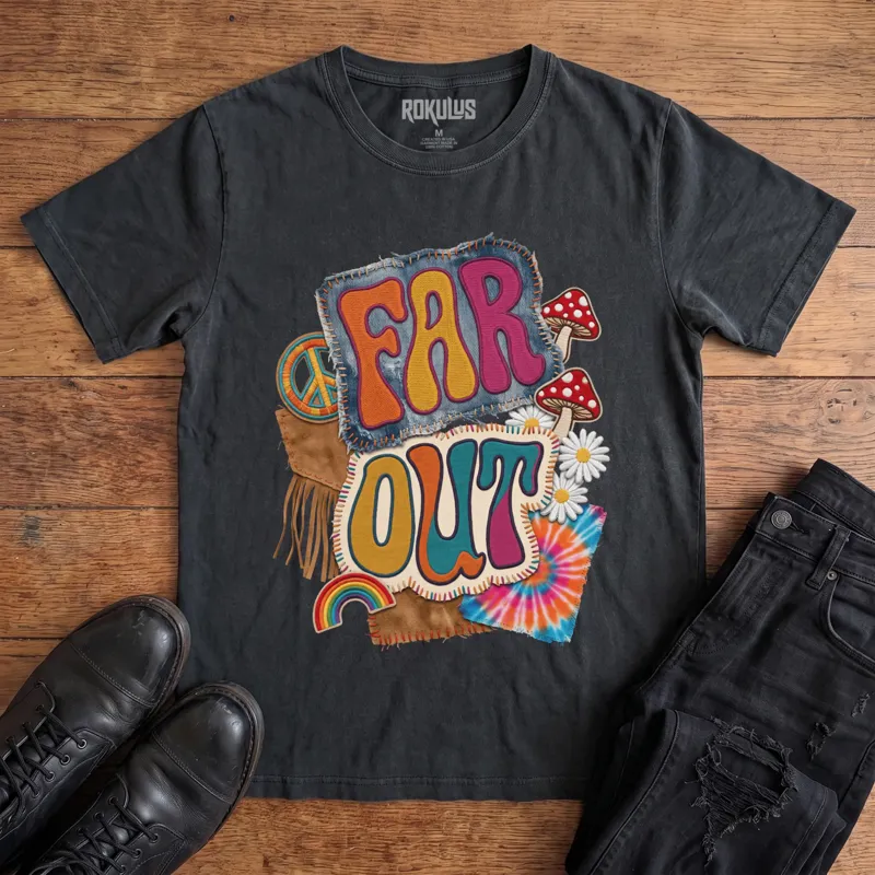 Washed black Rokulus Far Out vintage graphic tee laid flat on wood with black boots and jeans, front print showing a groovy 70s patch collage with mushrooms, daisies, a peace sign, rainbow, and tie-dye around puffy “Far Out” lettering
