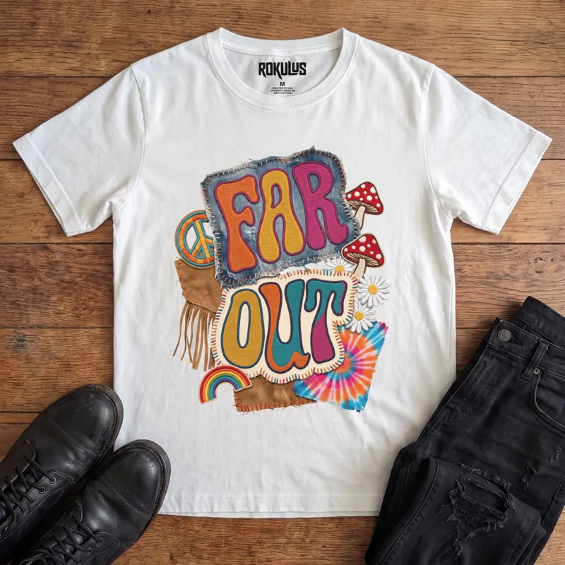 White Rokulus Far Out vintage graphic tee laid flat on wood with black boots and jeans, front print showing a groovy 70s patch collage with mushrooms, daisies, a peace sign, rainbow, and tie-dye around puffy “Far Out” lettering